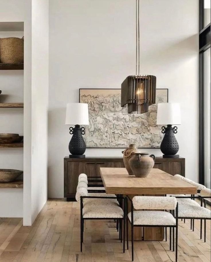 Warm modern dining room with a slatted wood pendant chandelier centered over an oak dining table