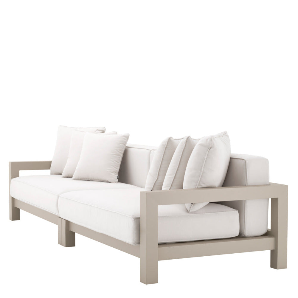 Beige outdoor sofa with white cushions on a white background