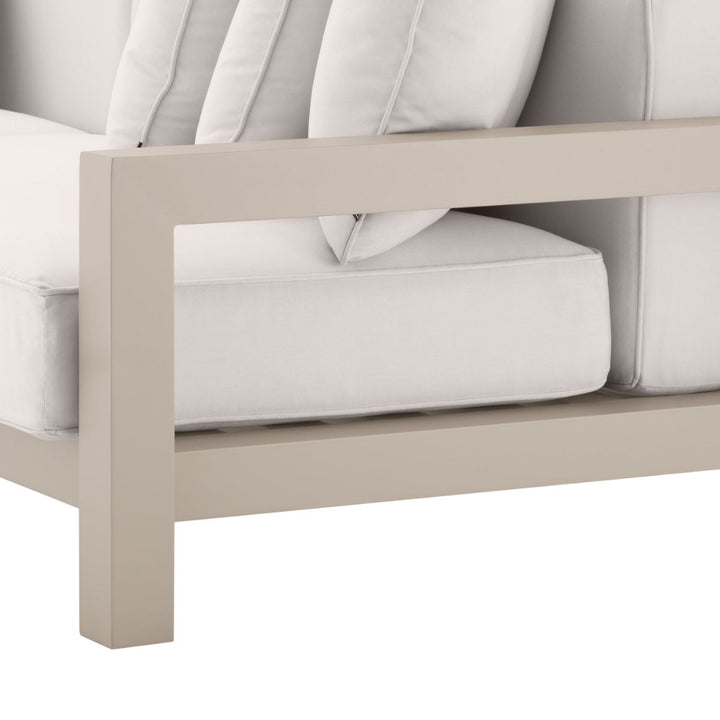 Close-up of a beige outdoor sofa with white cushions on a white background