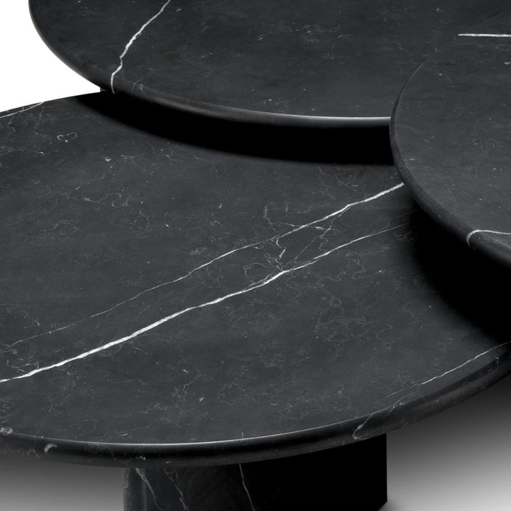 Black marble table with a smooth surface and subtle veining.