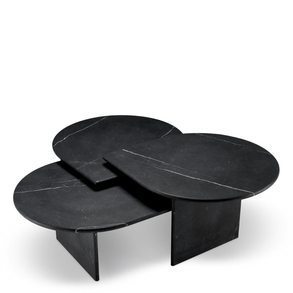 Set of three black marble coffee tables on a white background