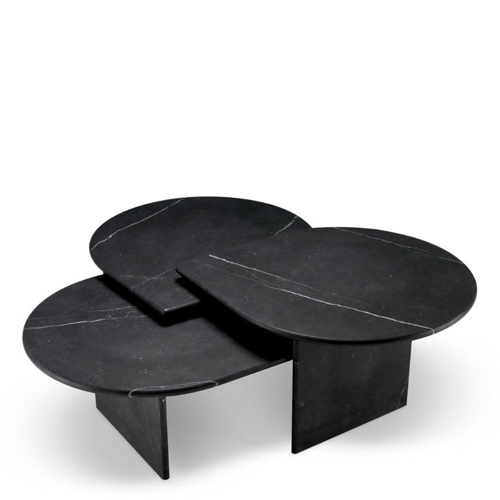 Set of three black marble coffee tables on a white background