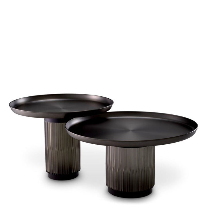 Two black coffee tables with textured cylindrical bases on a white background