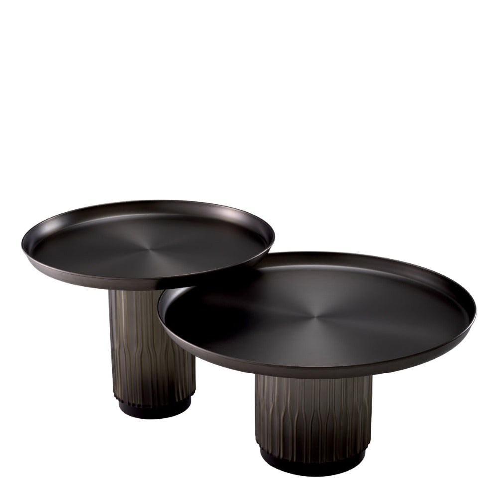 Two black round tables with cylindrical bases on a white background