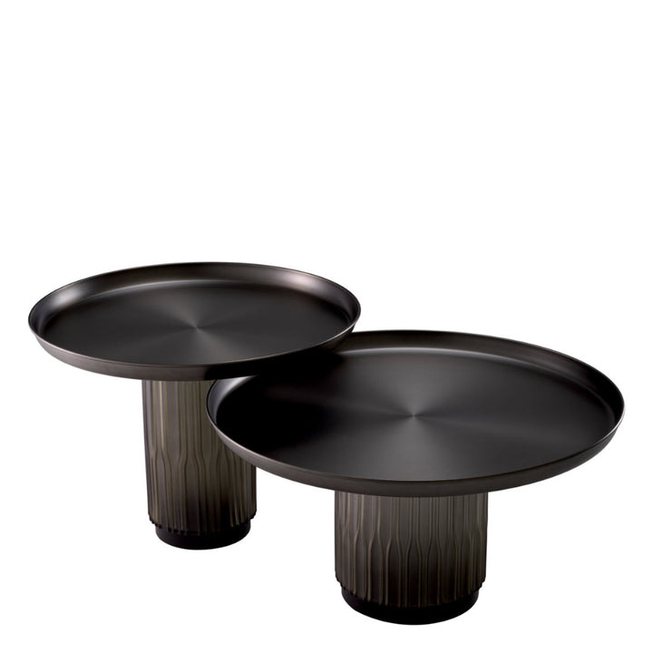 Two black round tables with cylindrical bases on a white background