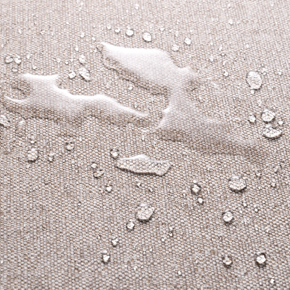 Close-up of light grey fabric with water