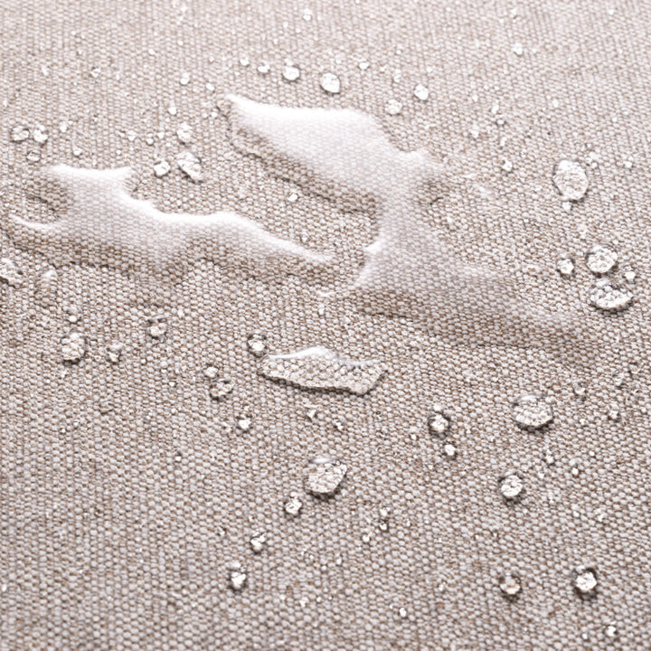 Close-up of light grey fabric with water