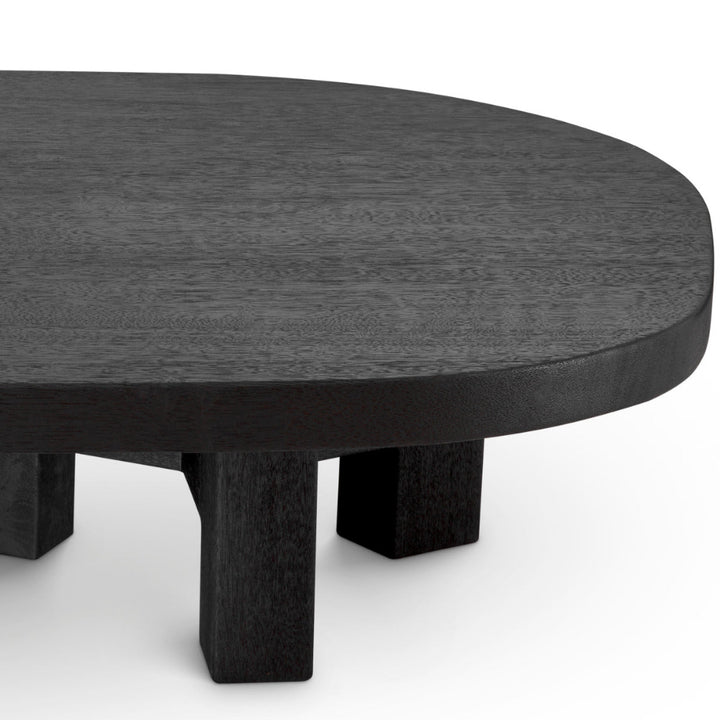 Round black table with thick legs on a white background