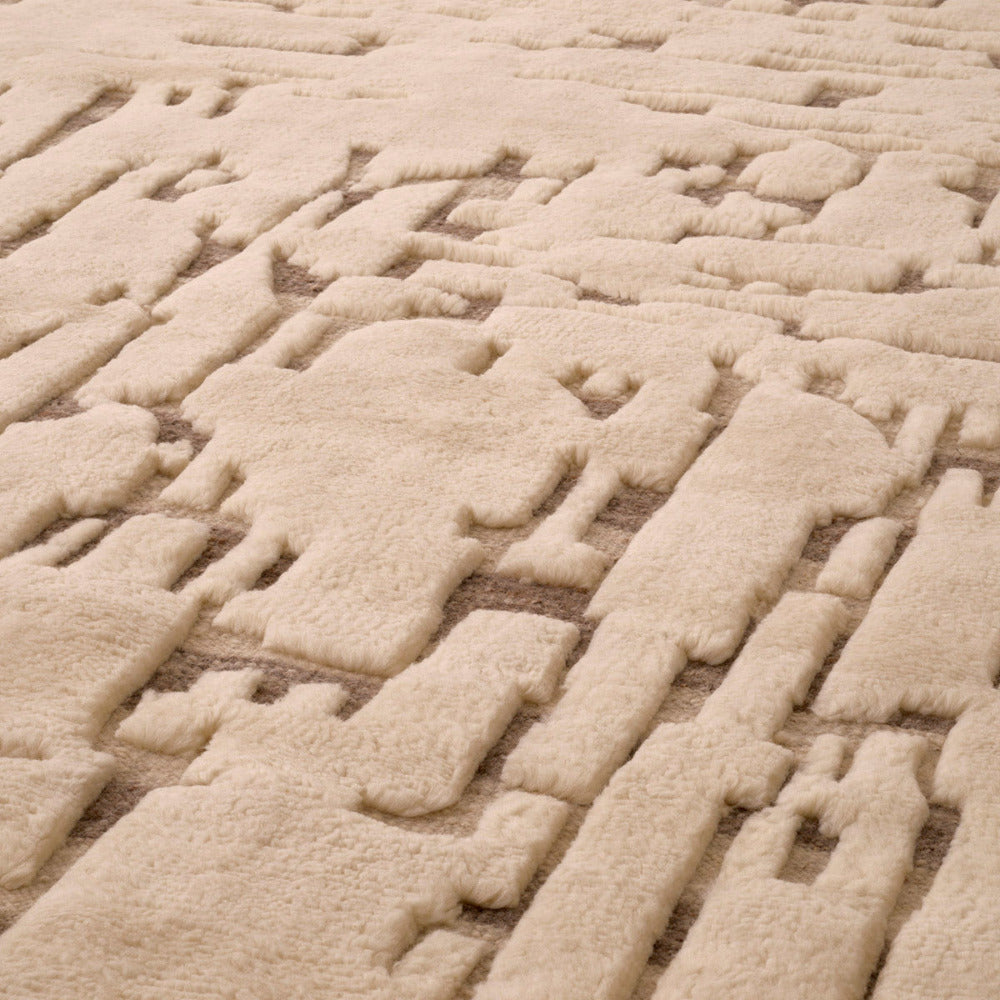 Close-up of textured ivory carpet with a woven pattern