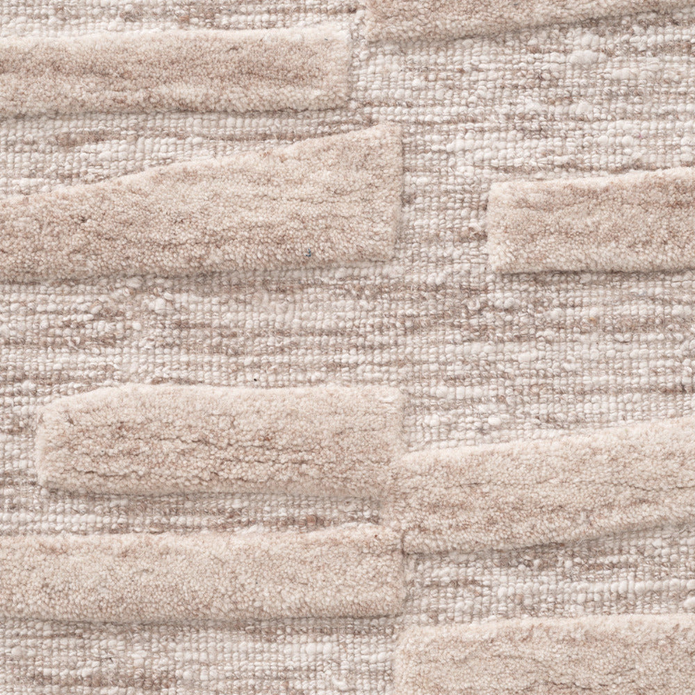 Close-up of a textured beige rug.