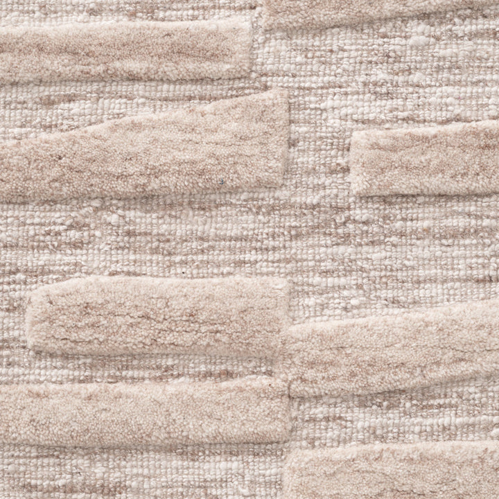 Close-up of a textured beige rug.