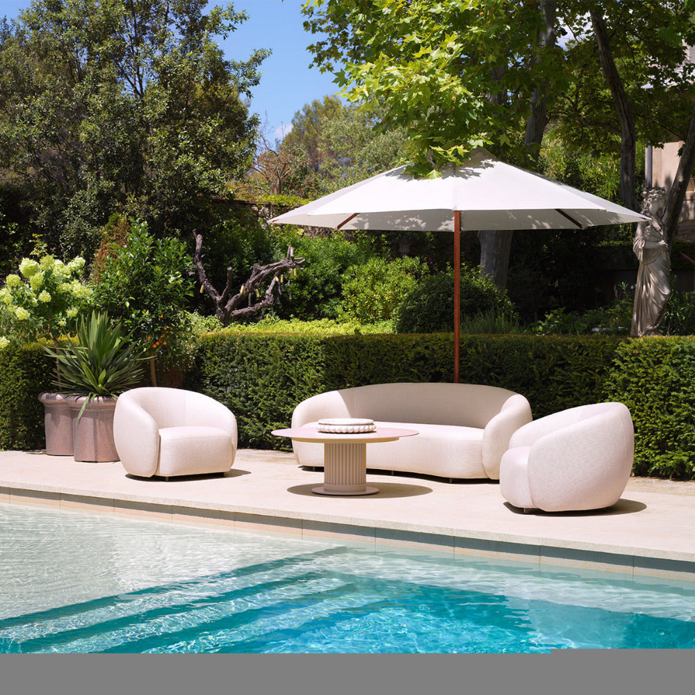 Outdoor pool with chairs, surrounded by trees
