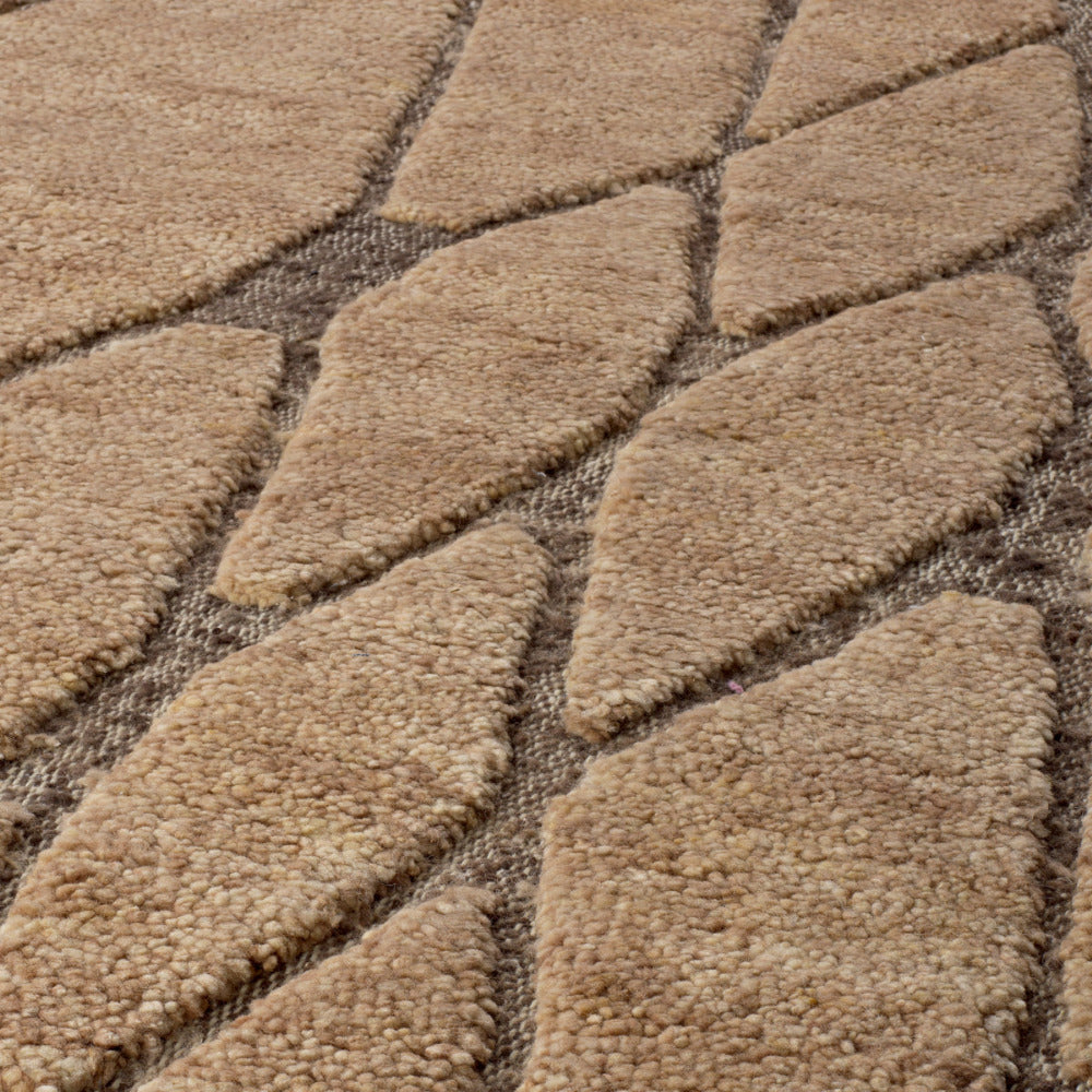 Close-up of a textured beige carpet with a diamond pattern