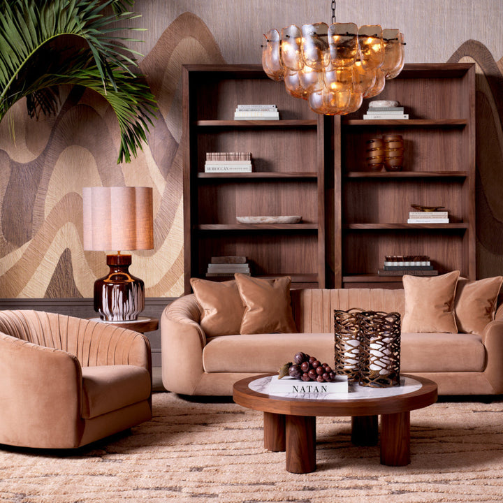 Modern living room with brown furniture, bookshelves, and decorative items.