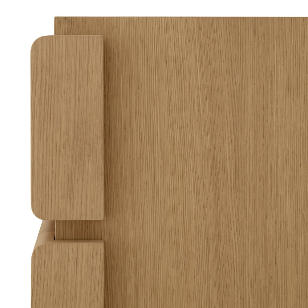 Close-up of a wooden dresser with a light brown finish