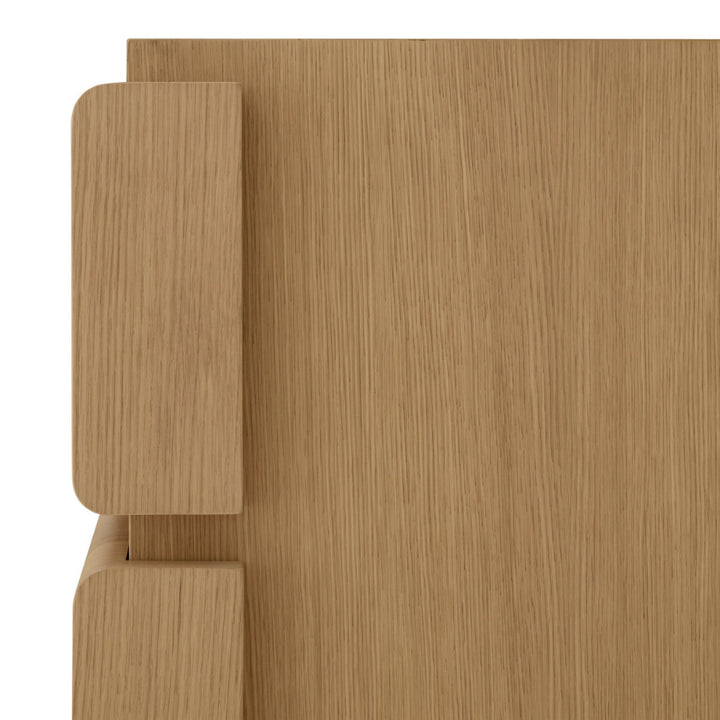 Close-up of a wooden dresser with a light brown finish