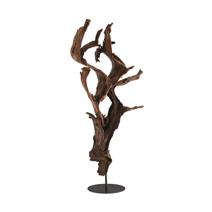 Driftwood sculpture on a stand against a white background