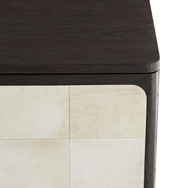 Close-up of a dark wooden cabinet corner with a light-colored floor.