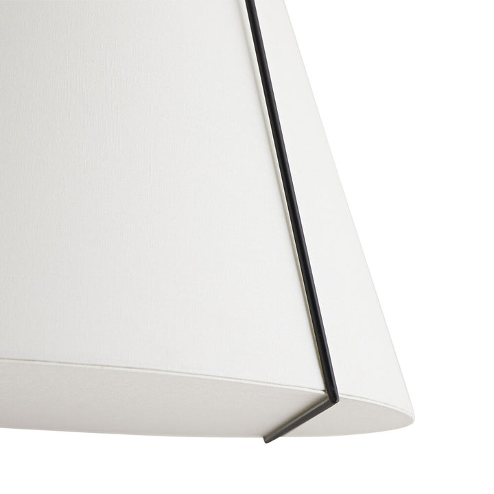 Close-up of a white pendant light with a black frame on a white background