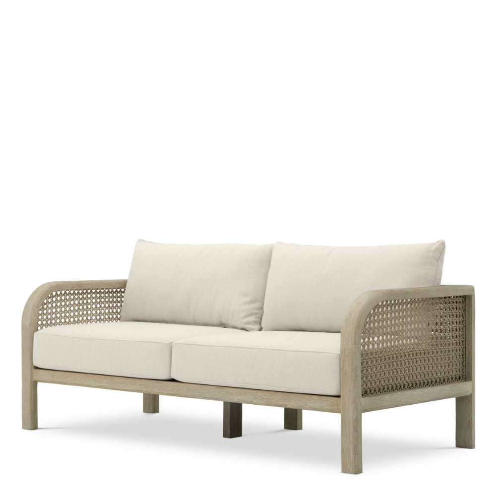 Beige outdoor sofa with wicker frame on a white background