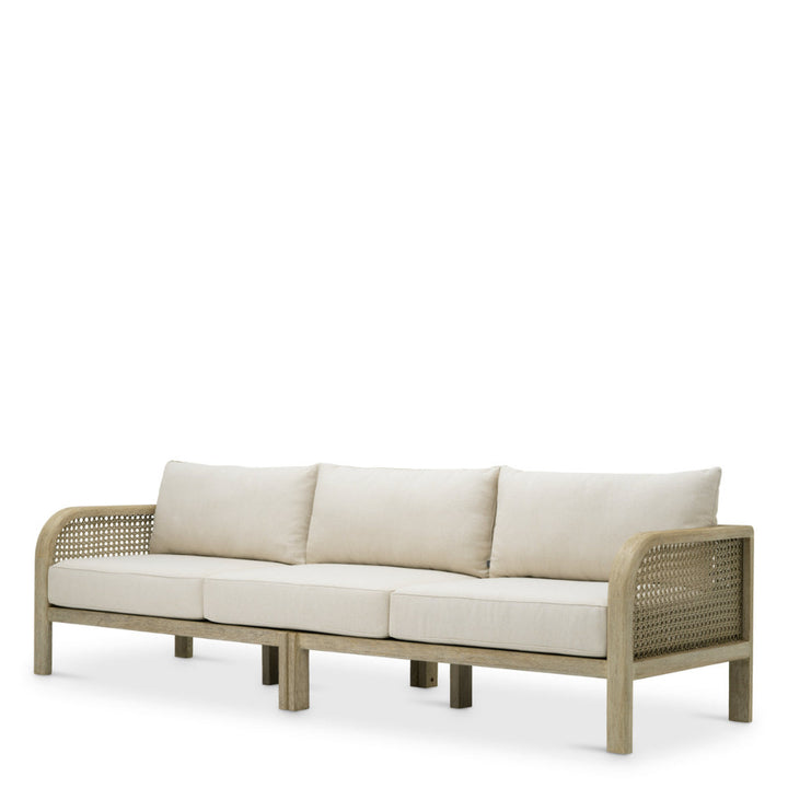 Beige outdoor sofa with wicker frame on a white background