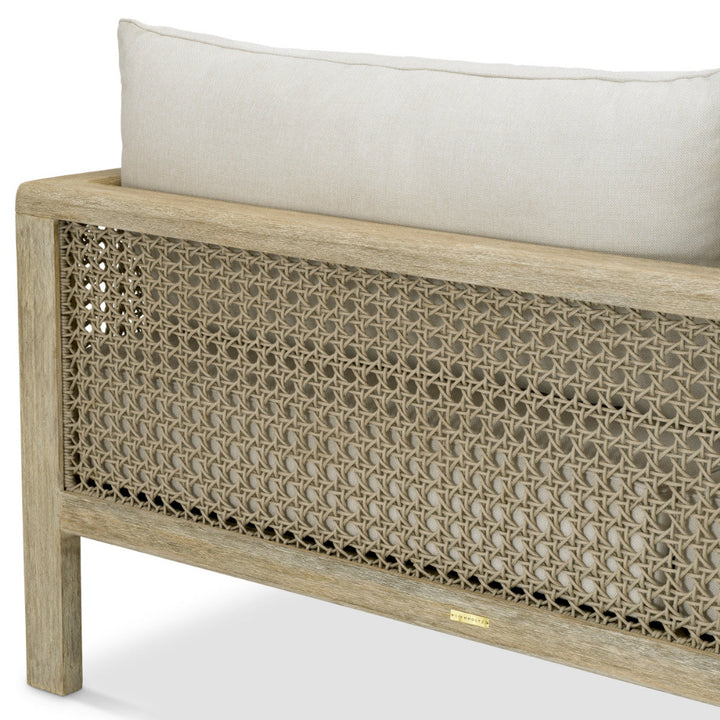 Wooden bench with woven backrest and white cushion on a white background
