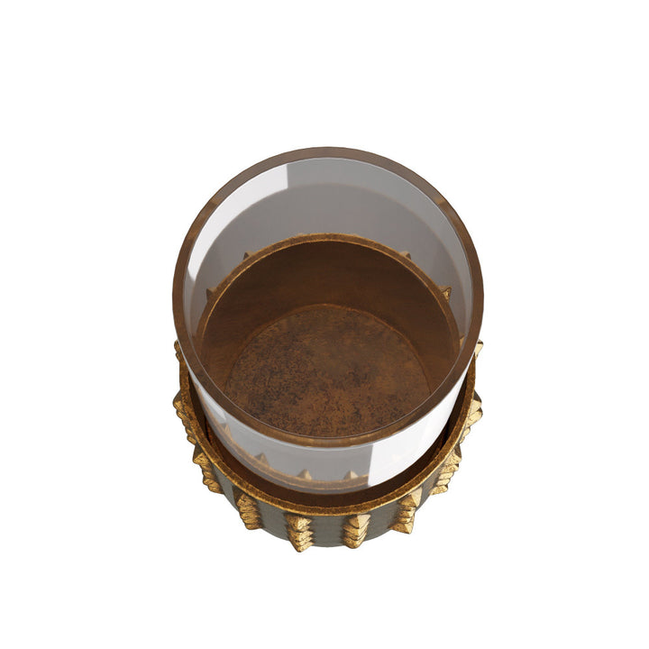 Decorative glass container with gold base on a white background