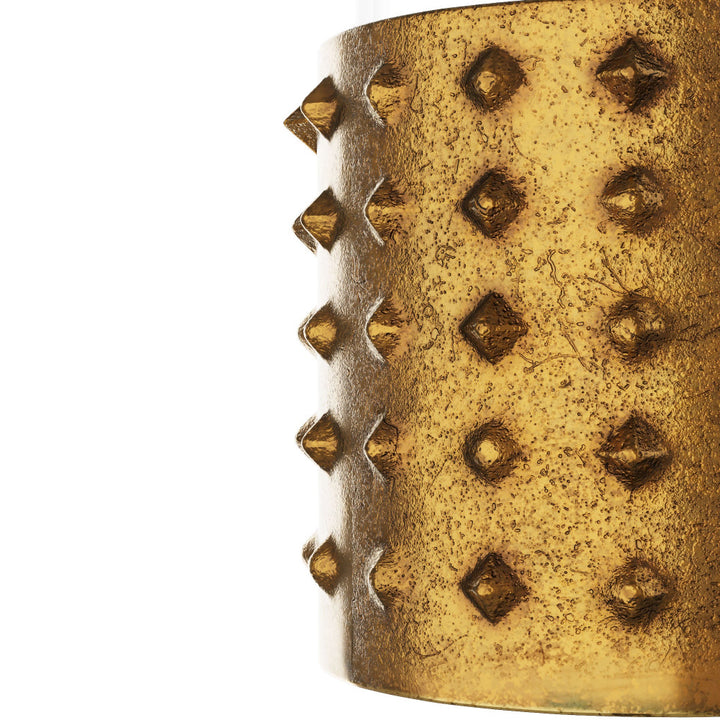 Close-up of a textured golden candle holder on a white background