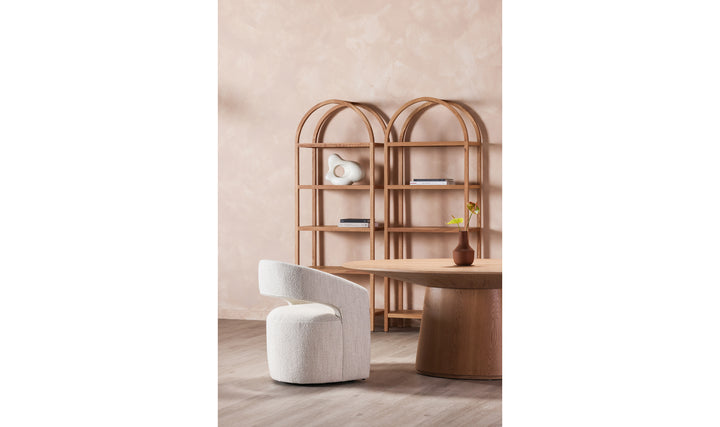 Modern interior with a white chair, wooden table, and shelves against a beige wall.