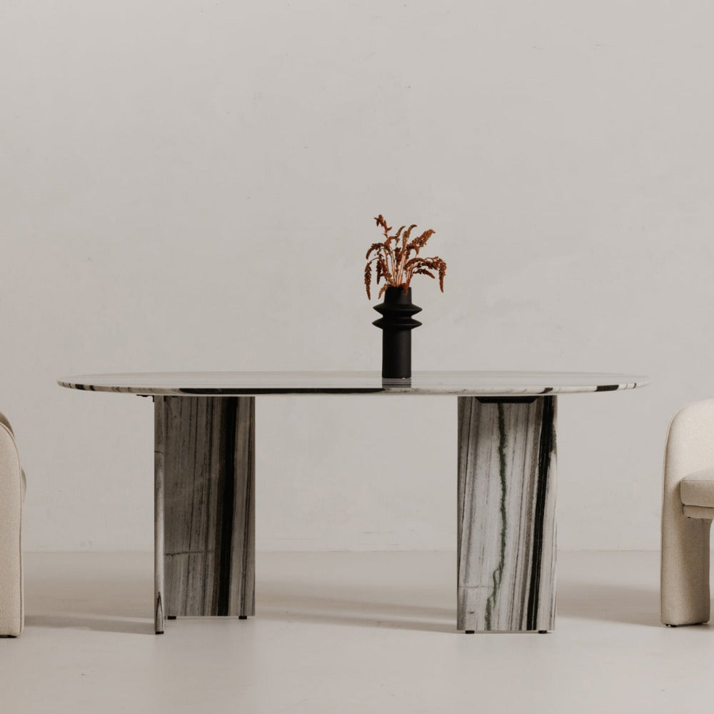 Modern dining table with two chairs on a plain background