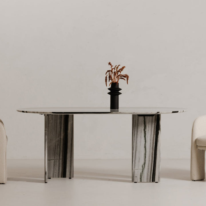 Modern dining table with two chairs on a plain background