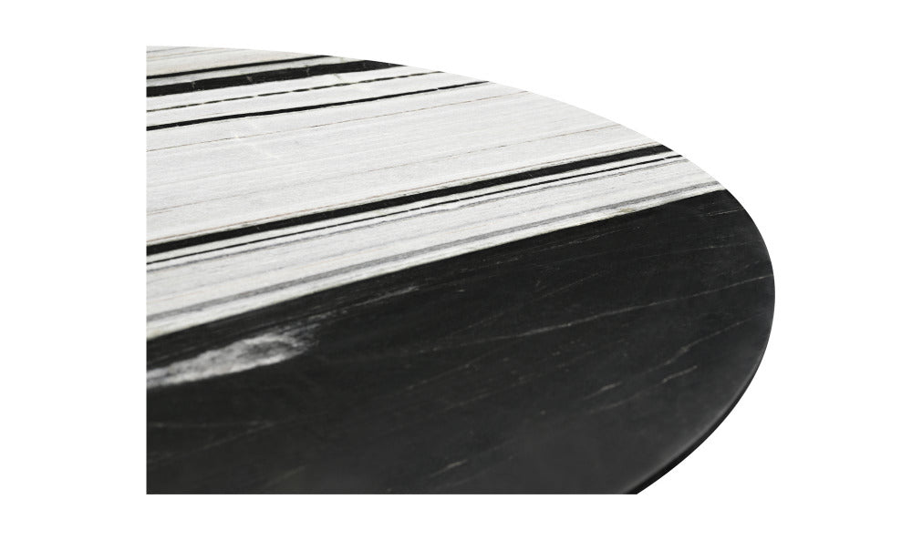 Round black marble table with a white and black striped pattern on top
