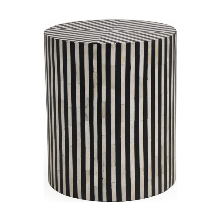 Cylindrical side table with black and white striped pattern on a white background
