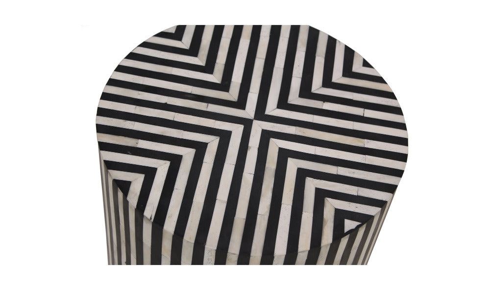 Black and white geometric patterned side table on a white background
