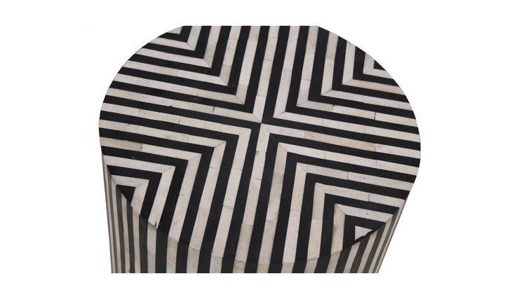 Black and white geometric patterned side table on a white background