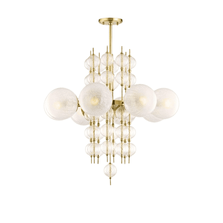 The Calypso 8-Light Chandelier featuring a luxurious gold finish, beautifully displayed in a modern living space, enhancing the decor with its warm and inviting glow