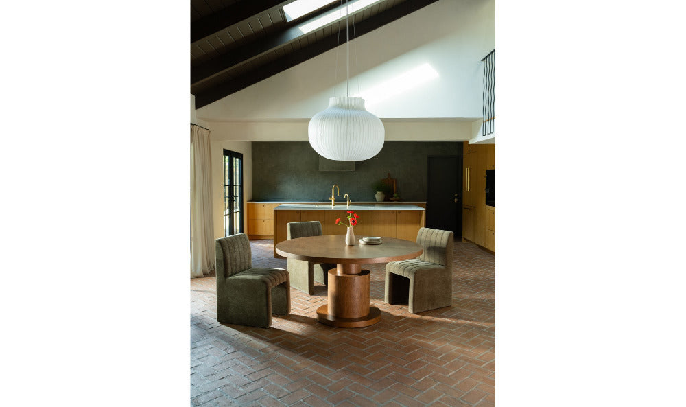 Modern interior with a round table and chairs in a well-lit room.