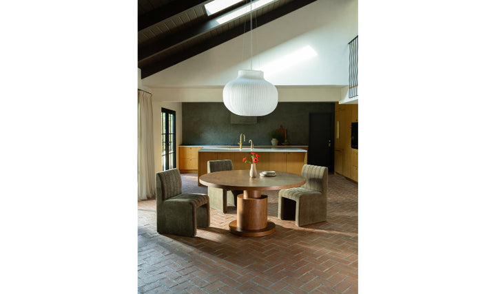 Modern interior with a round table and chairs in a well-lit room.