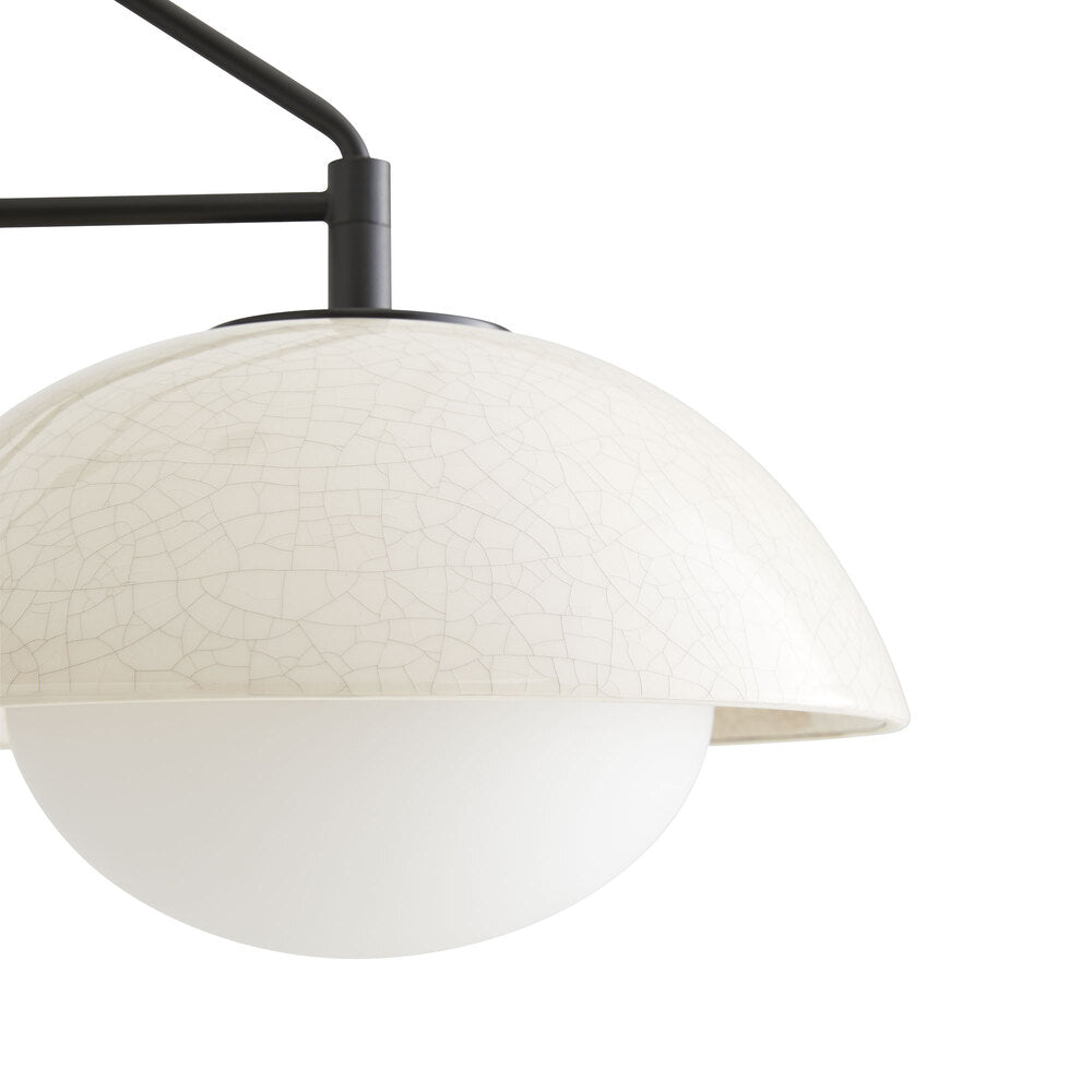 Modern pendant light with white textured shade and black metal arm on a white background