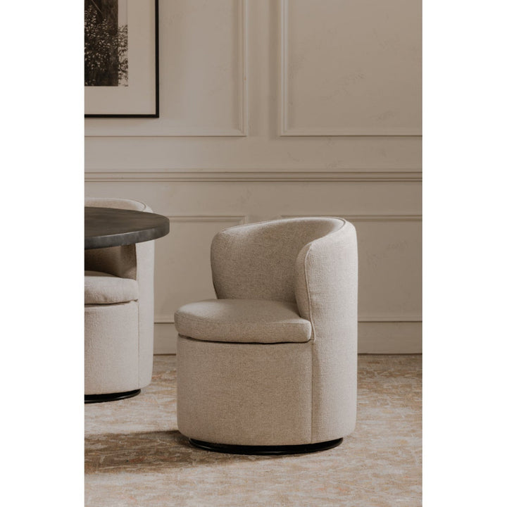 Beige swivel chair in a room with neutral walls and a small table.