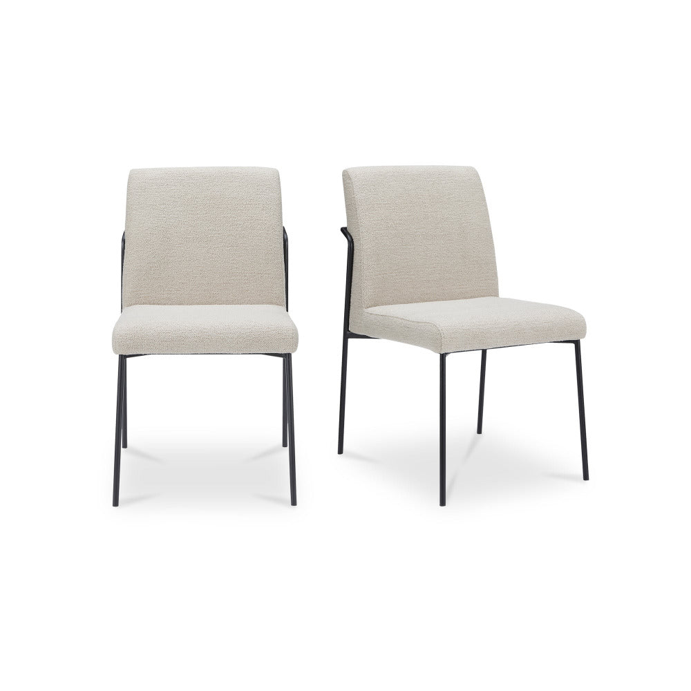 Two ivory chairs with black legs on a white background