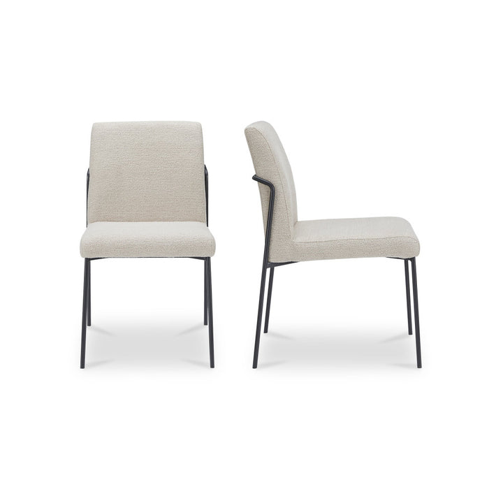 Two ivory chairs with black legs on a white background