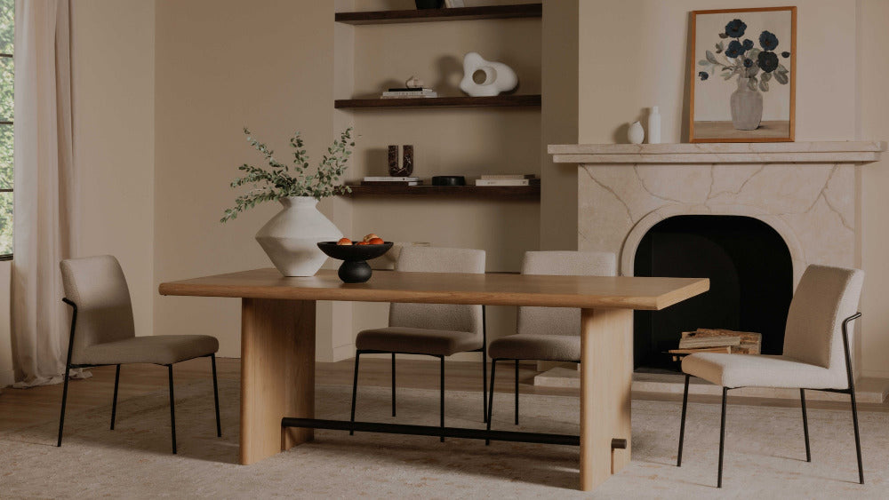 Dining room with wooden table and chairs in front of a fireplace