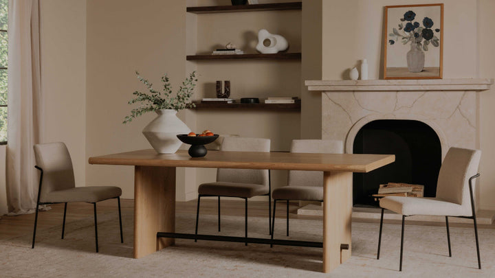 Dining room with wooden table and chairs in front of a fireplace
