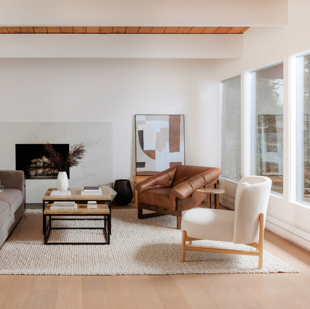 Modern living room with a fireplace, sofas, and decor.