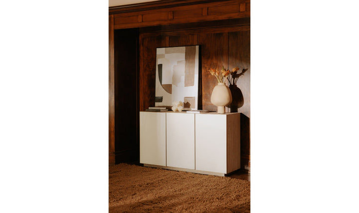 White cabinet against a wooden wall with decorative items.