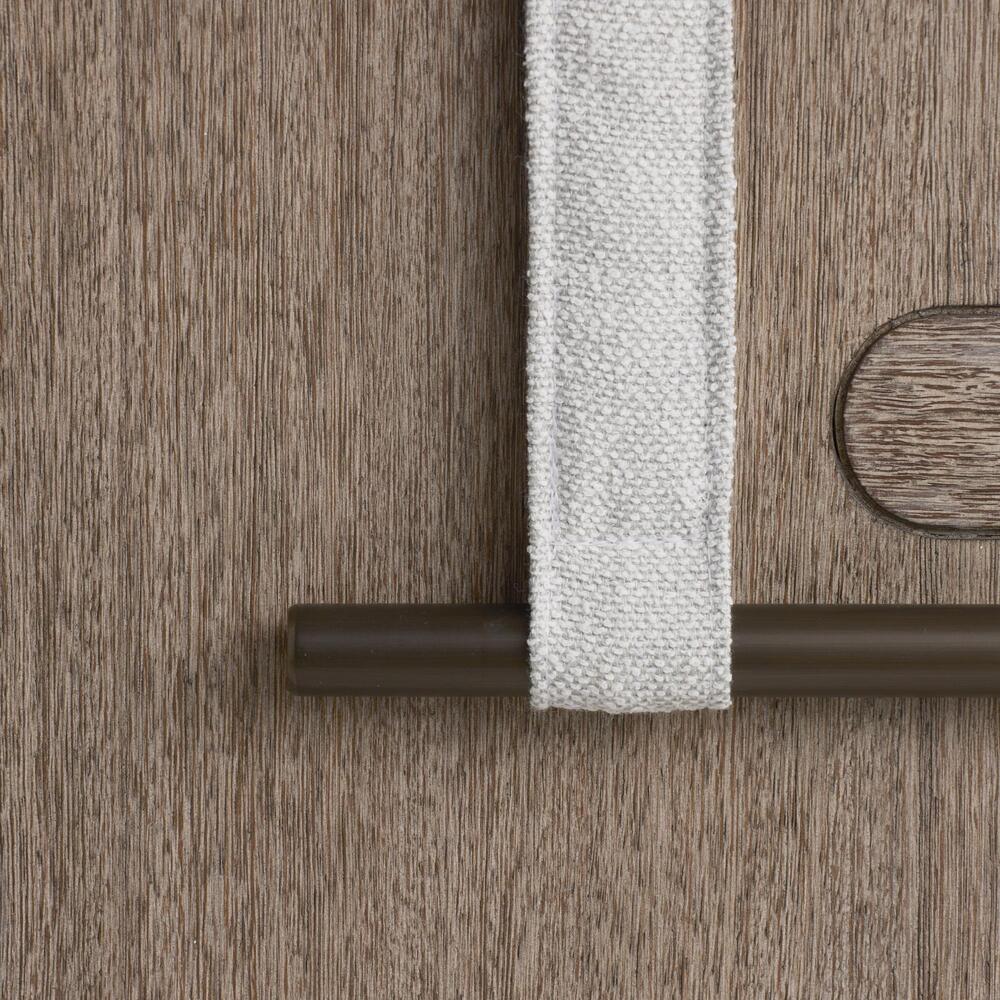 Close-up of a wooden surface with a white textured strip and a brown cylindrical object.