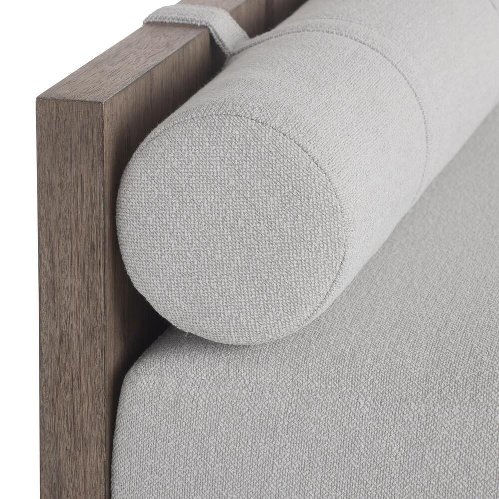 Close-up of a gray upholstered daybed on a white background