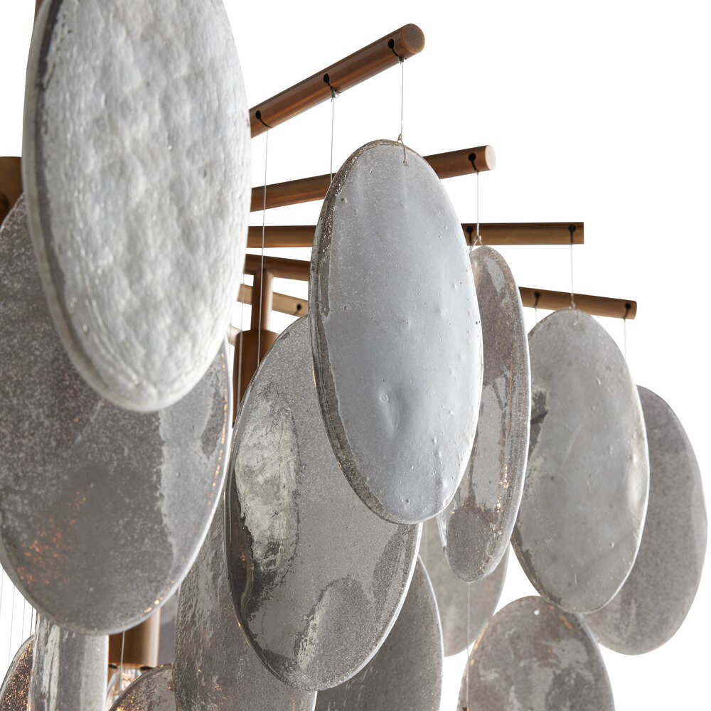 Decorative hanging mobile with oval-shaped stones on a white background