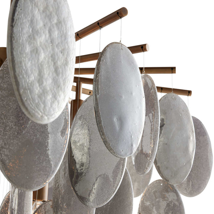Decorative hanging mobile with oval-shaped stones on a white background
